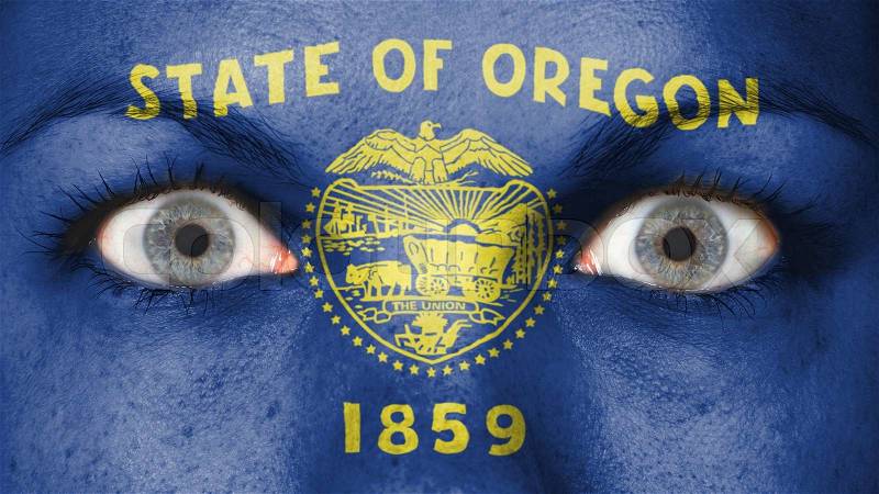 Close up of eyes. Painted face with flag of Oregon, stock photo