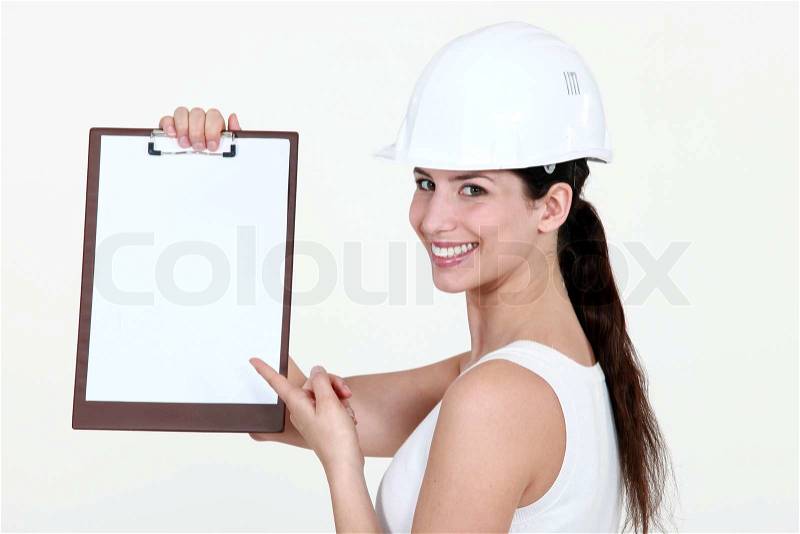 8350506-cute-female-apprentice-pointing-at-clipboard.jpg