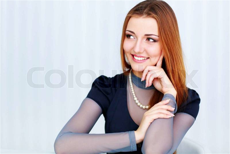 Portrait of a beautiful cheerful woman looking right at copyspace, stock photo