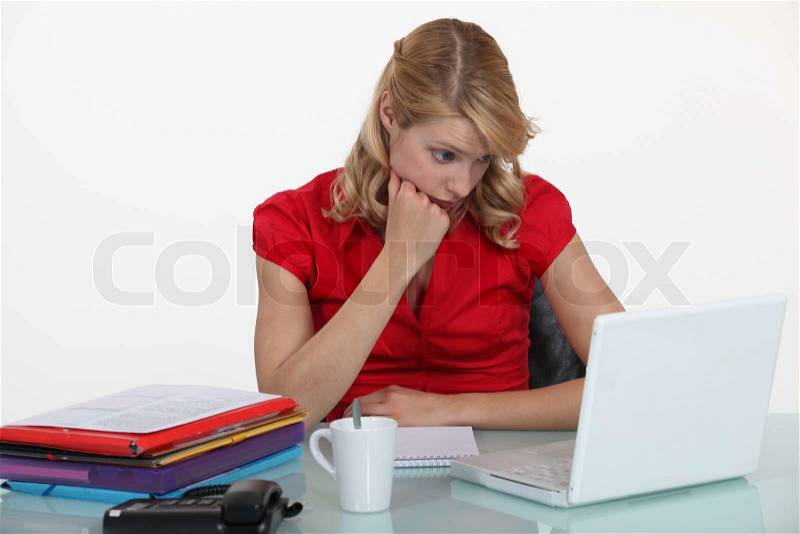 Bored woman in front of computer, stock photo