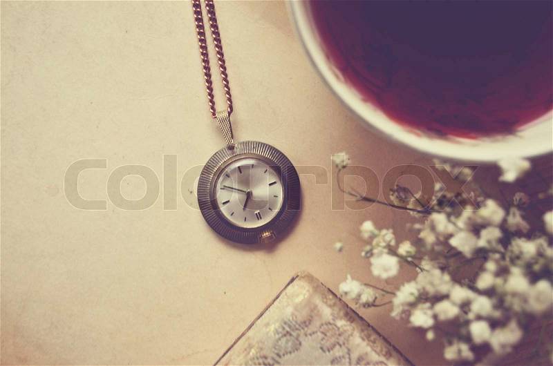 Old blank paper and old watch with cup of tea, stock photo