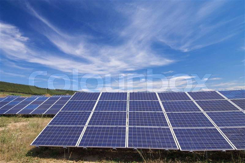 Solar field with cloudy sky, stock photo