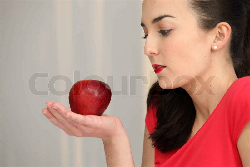 Stock image of &#39;Woman holding a red apple in the palm of her hand&#39; - 8374783-woman-holding-a-red-apple-in-the-palm-of-her-hand