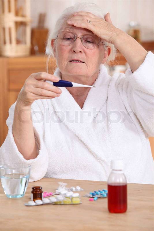 Woman taking temperature, stock photo