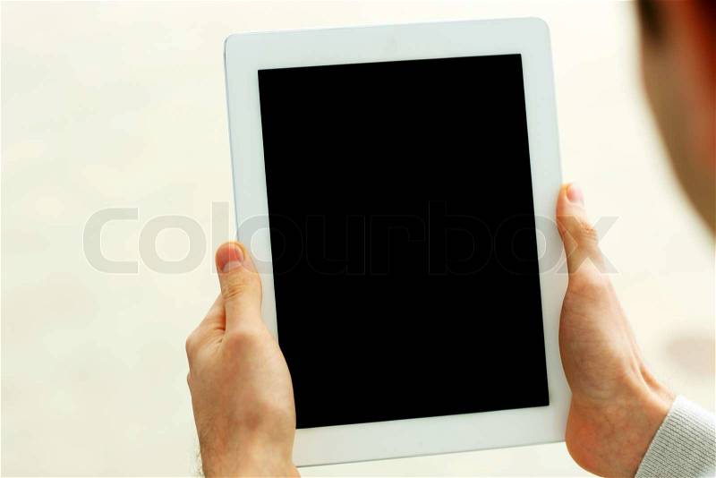 Closeup image of male hands showing display of tablet computer isolated on a white background, stock photo