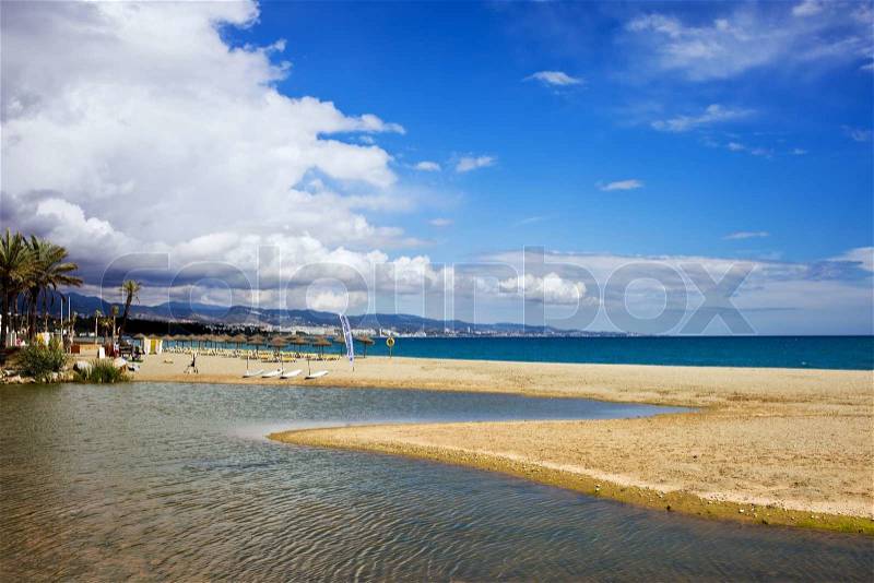 Beach, river and the sea vacation scenery on Costa del Sol in Spain, located between Marbella and Puerto Banus, waters of Green River Spanish: Rio Verde and Mediterranean Sea, stock photo