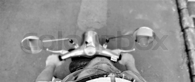 Hairy guy on a scooter, stock photo