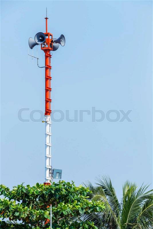 Outdoor speaker and spotlight on steel pole in public park, stock photo