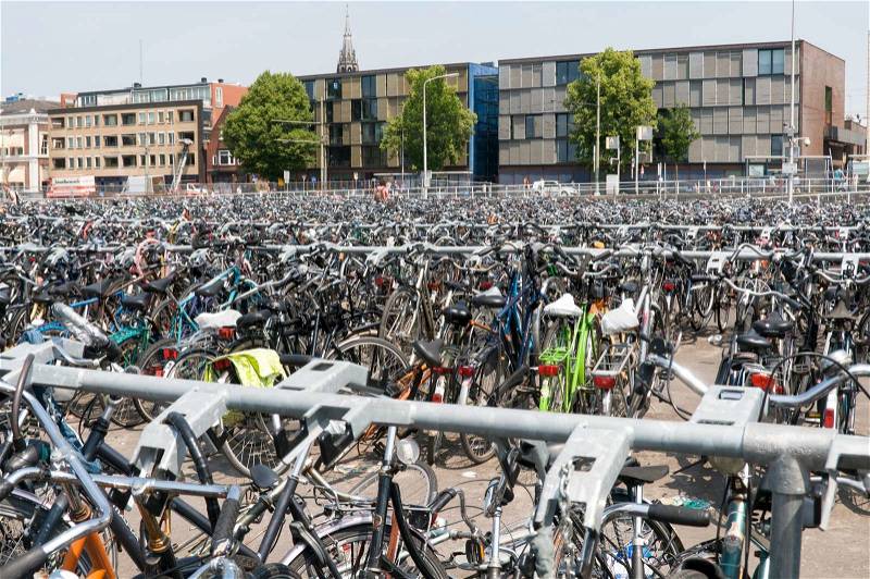 Many bikes at railroad station in holland europe, stock photo