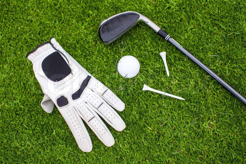 Golf equipment on green grass, stock photo