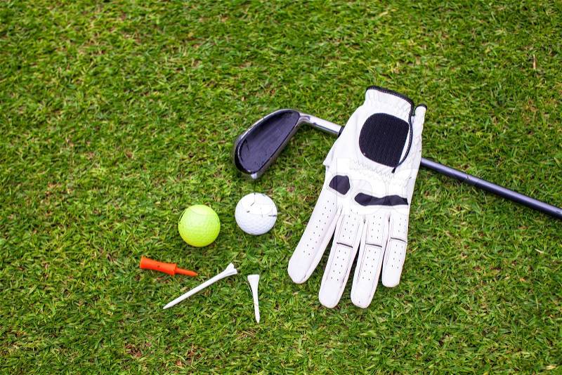 Golf equipment on green grass, stock photo
