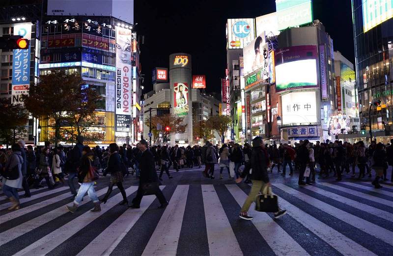 TOKYO - NOVEMBER 28: Pedestrians at the famed crossing of Shibuya district November 28, 2013 in Tokyo, JP. Shibuya is a fashion center and nightlife area. , stock photo
