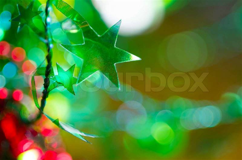 Green star on abstract bokeh background, stock photo