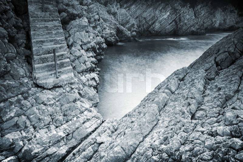 Old stone stairs goes down to the sea backwater. Montenegro, stock photo