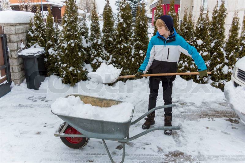 Snow is shoveled away from a house. snow removal in winter, stock photo