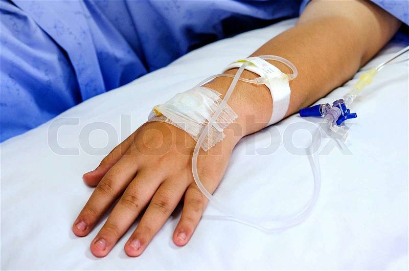 IV solution in patient hand, stock photo
