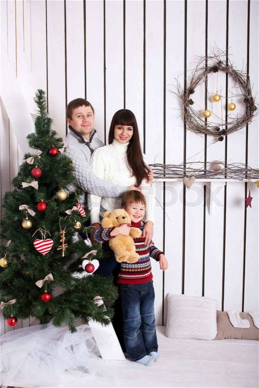 Happy family near the Christmas tree. Christmas, New Year, holiday concept, stock photo