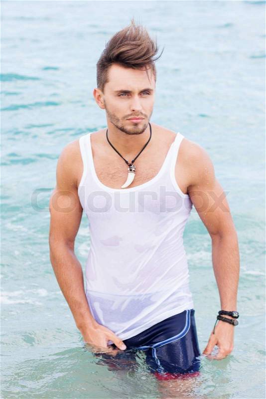 Portrait of cute young man on the beach, stock photo
