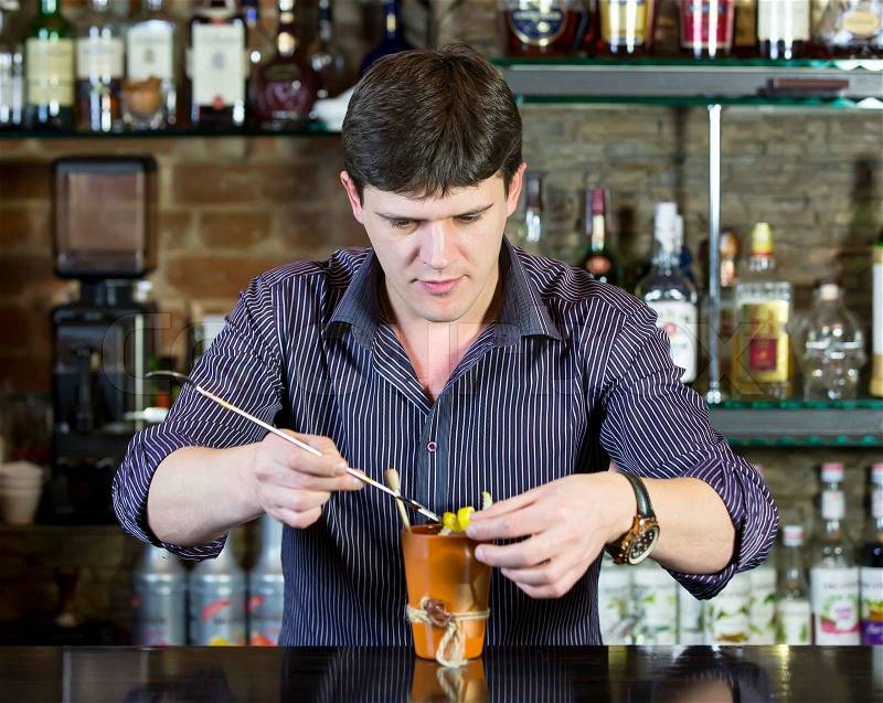 Multiple titlesyoung man working as a bartender in a nightclub bar, stock photo