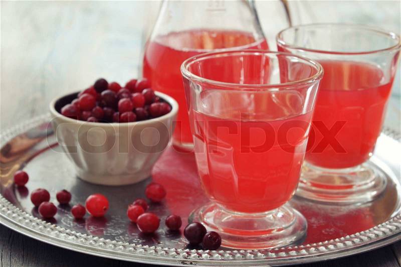 Cranberry juice in glass with fresh berry on metal tray, stock photo