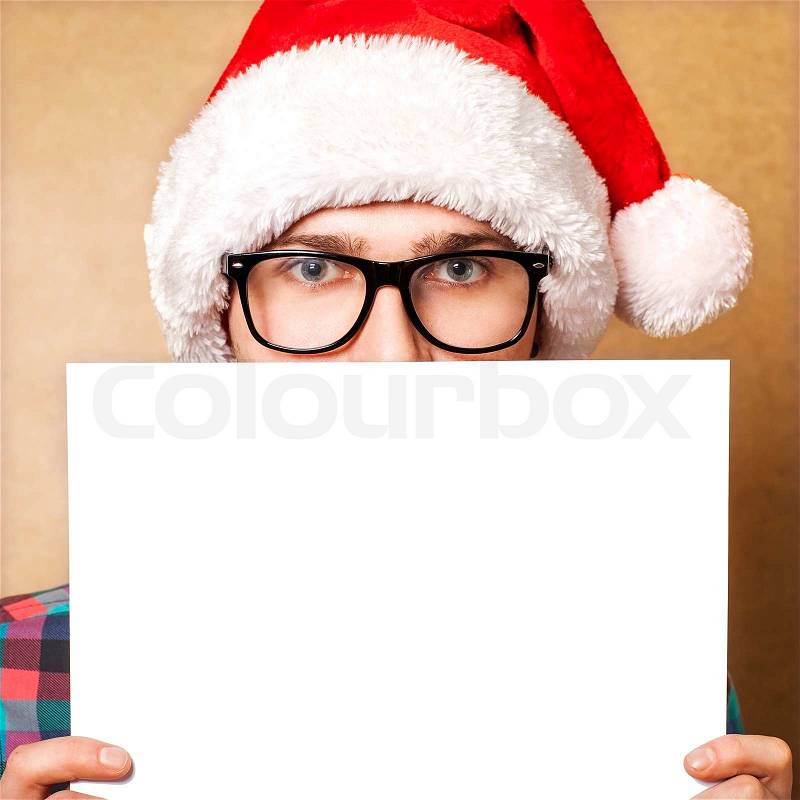 Santa Claus pointing in white blank sign with smile, isolated on background, stock photo