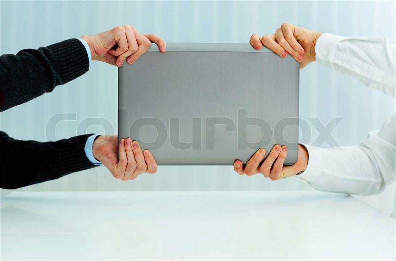 Closeup image of a business hands pulling a laptop. Competition for new vacation, stock photo