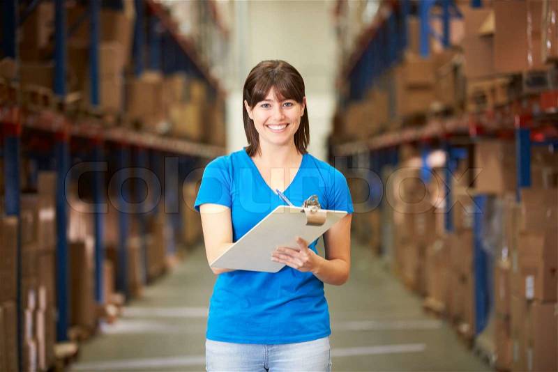 Female Worker In Distribution Warehouse, stock photo