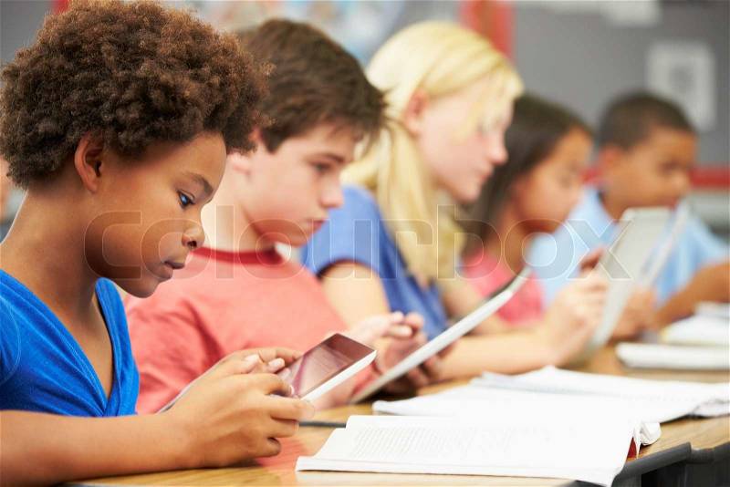 Pupils In Class Using Digital Tablet, stock photo