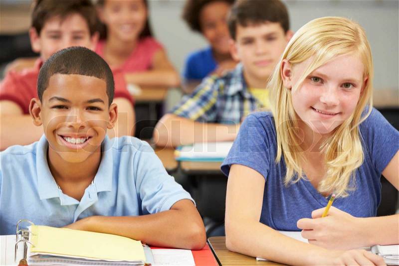 Pupils Studying At Desks In Classroom, stock photo