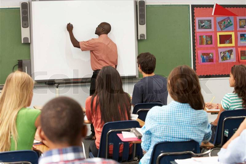 Teacher Using Interactive Whiteboard During Lesson, stock photo