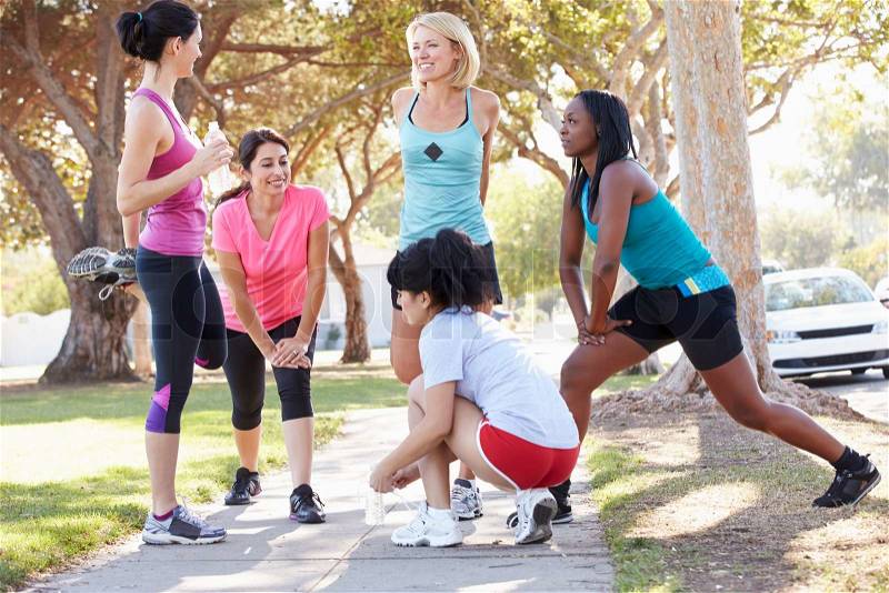 Group Of Female Runners Warming Up Before Run, stock photo