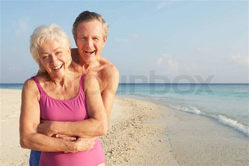 Portrait Of Senior Couple On Tropical Beach Holiday, stock photo