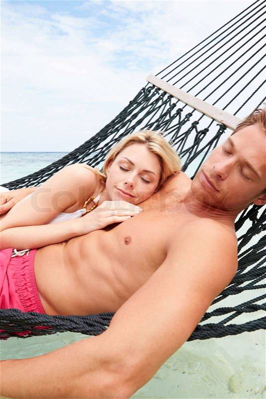 Couple Relaxing In Beach Hammock, stock photo