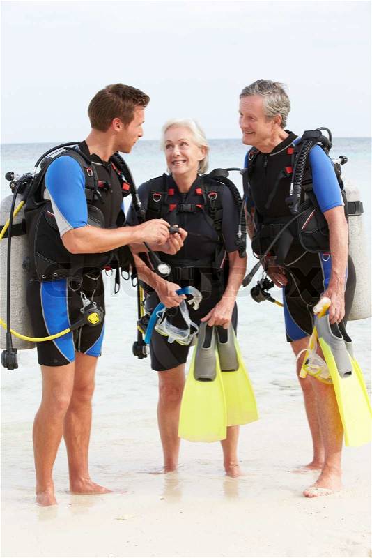 Senior Couple Having Scuba Diving Lesson With Instructor, stock photo