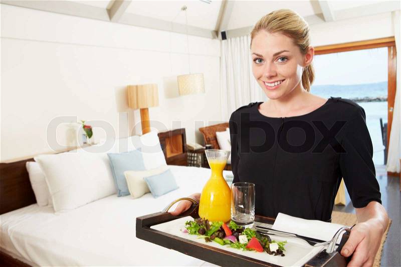 Portrait Of Hotel Worker Delivering Room Service Meal, stock photo