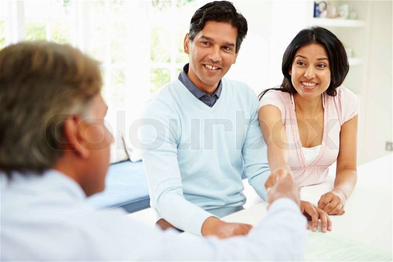 Indian Couple Meeting With Financial Advisor At Home, stock photo