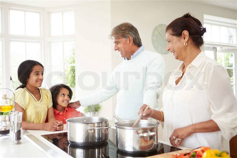 Grandparents And Grandchildren Cooking Meal At Home, stock photo