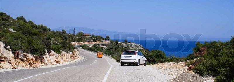 Alone car on a sunny road at sea coastline , stock photo