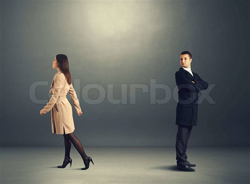 Young woman going out and man looking at her, stock photo