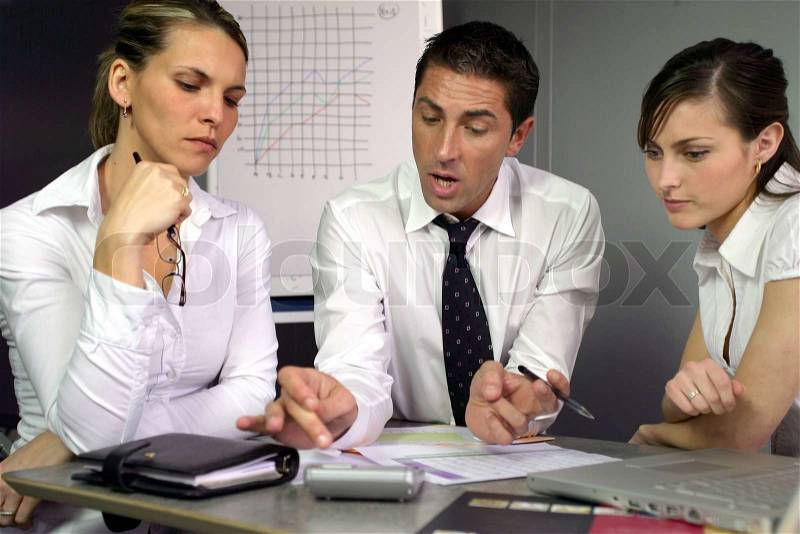 Businesspeople discussing performance, stock photo