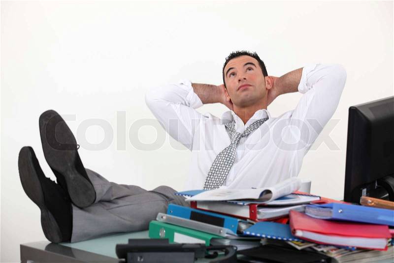 Businessman reclining in his chair, stock photo