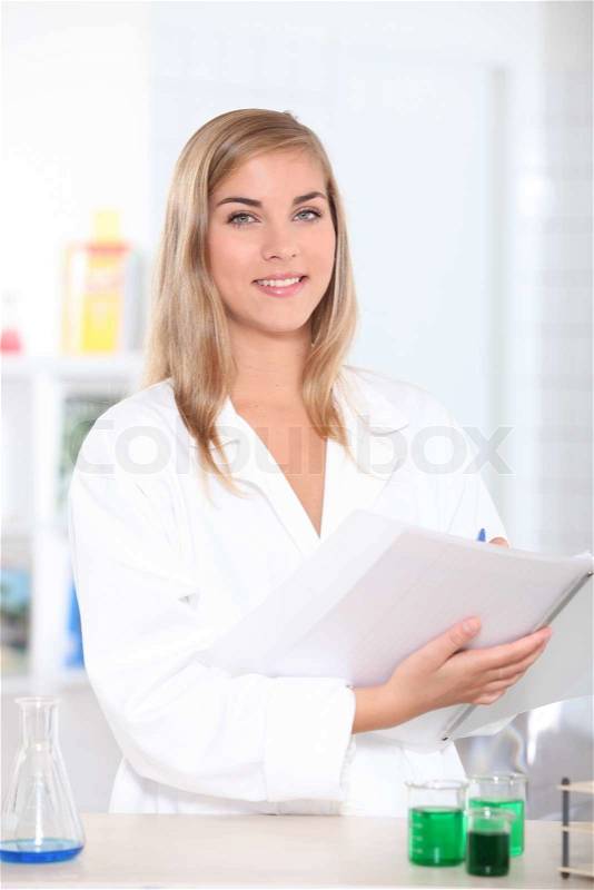 Science student noting results, stock photo