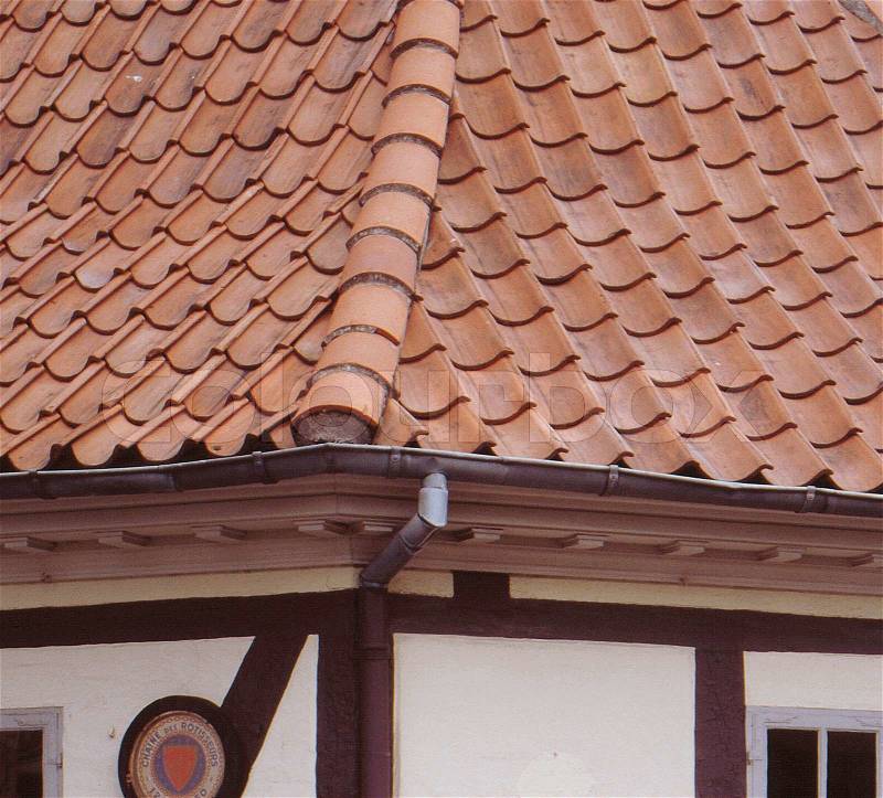 Close-up on brick roof and rain gutter of scandinavian house, stock photo