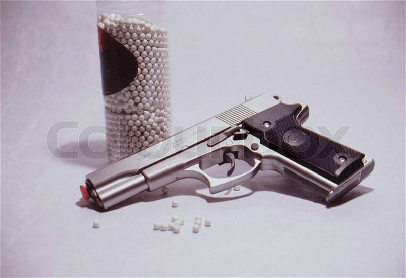Close-up on toy gun on white background, stock photo