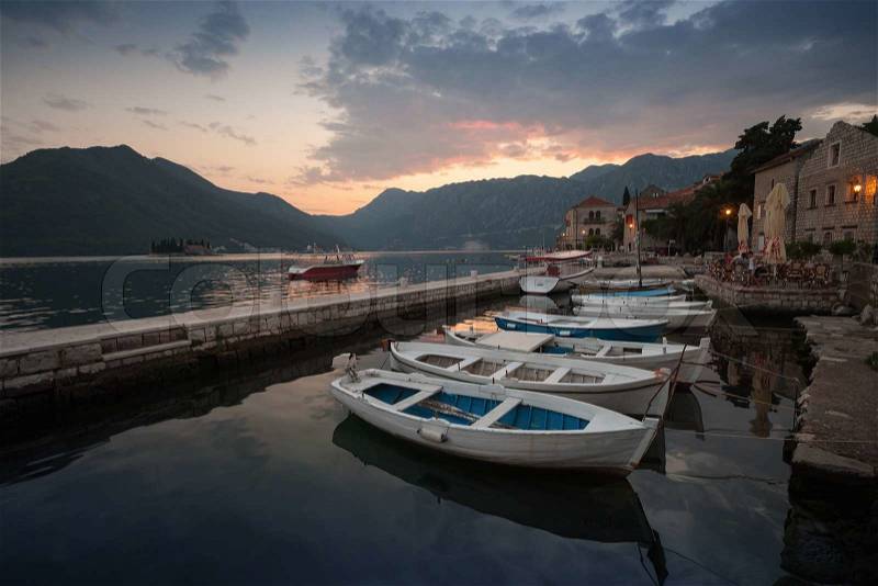 Fishing boats float moored in Perast. Bay of Kotor, Montenegro, stock photo