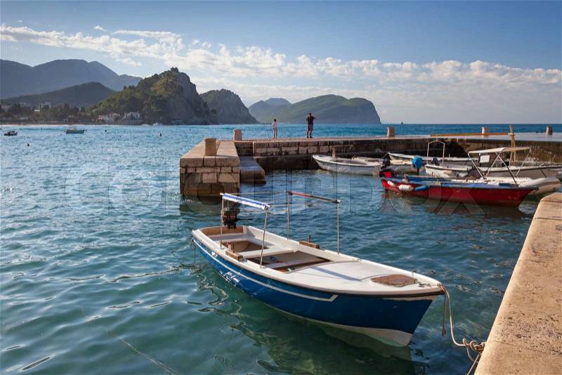 Fishing boats float moored in Petrovac, Montenegro, stock photo