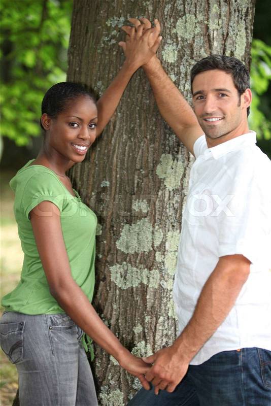 Couple touching tree, stock photo