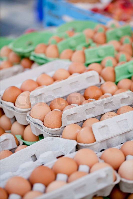 Group of brown eggs in carton box closeup market outdoor, stock photo