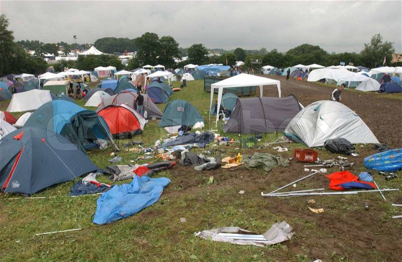 Tents and trash on campsite after a music festival, stock photo