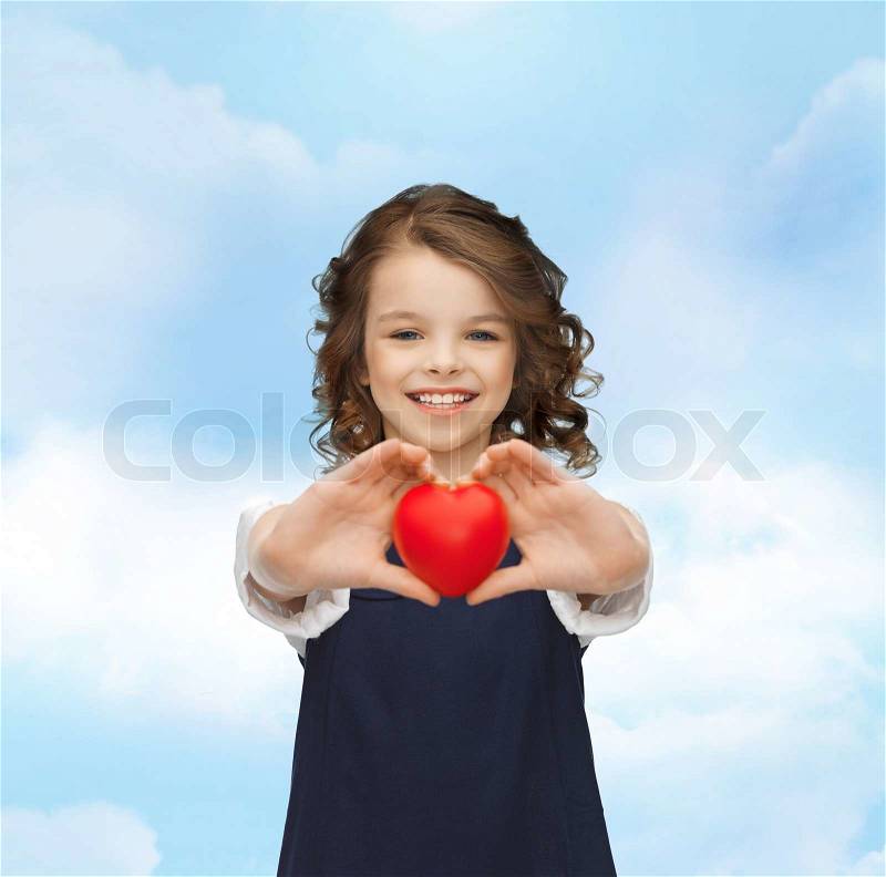 Love, children and happiness concept - beautiful girl with small heart, stock photo